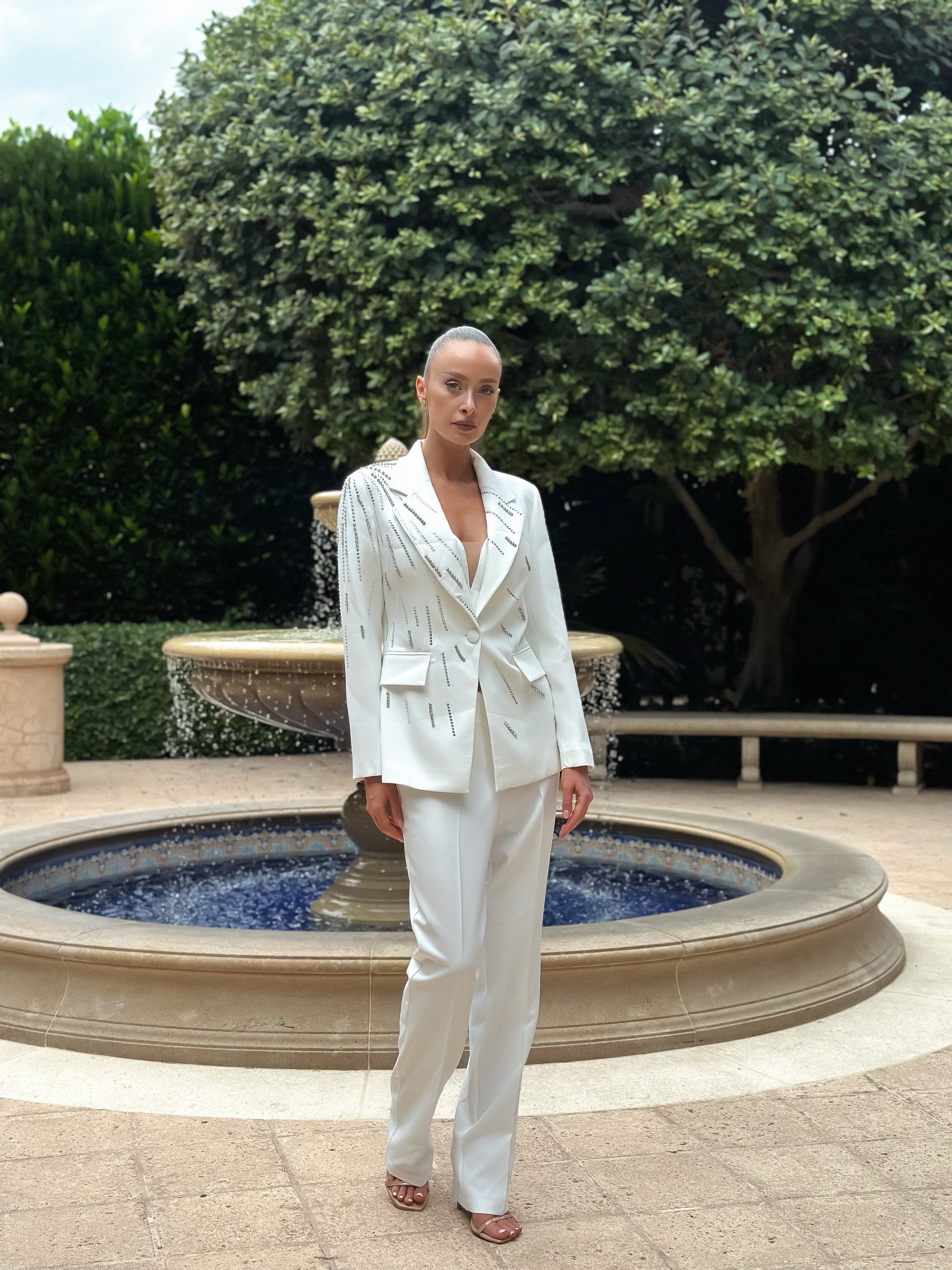 Sophisticated "Pearl Prestige Suit" featuring a tailored white blazer with silver embellishments and wide-leg trousers, perfect for formal events and business occasions.