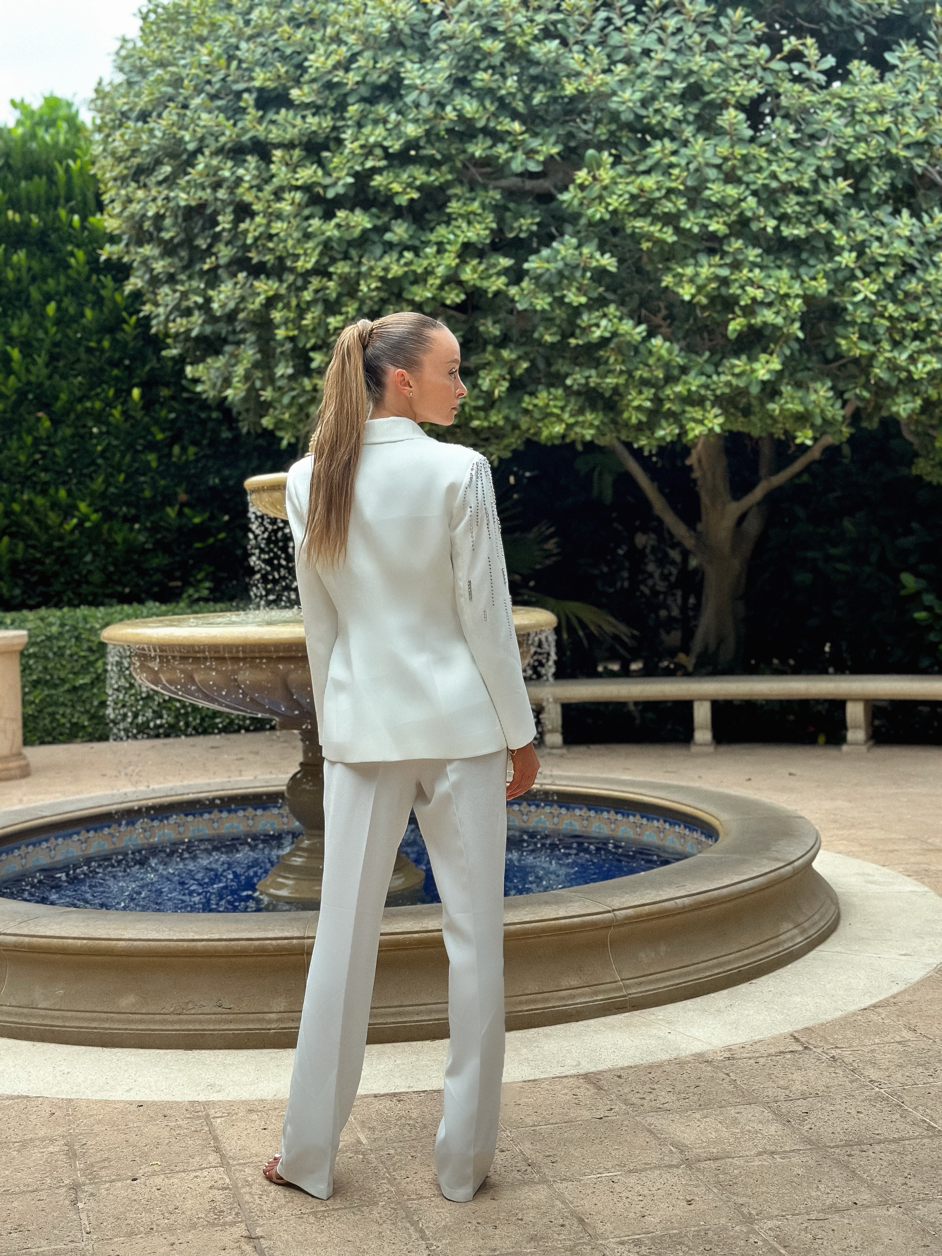 Sophisticated "Pearl Prestige Suit" featuring a tailored white blazer with silver embellishments and wide-leg trousers, perfect for formal events and business occasions.