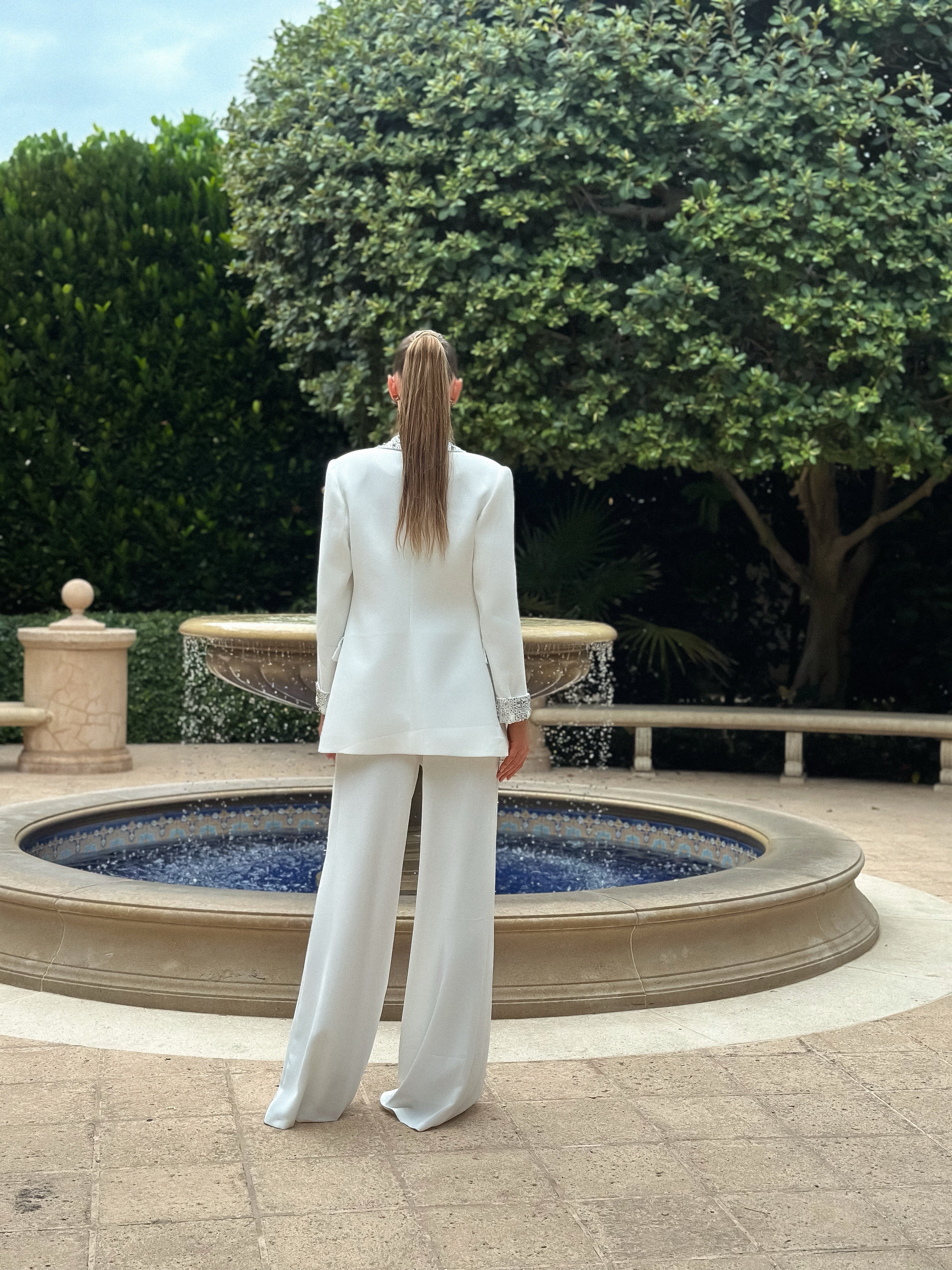 Sophisticated "Pearl Prestige Suit" featuring a tailored white blazer with silver embellishments and wide-leg trousers, perfect for formal events and business occasions.